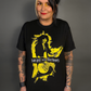Person wearing a black t-shirt with a graphic design of Joan Jett and the Blackhearts on a gray background